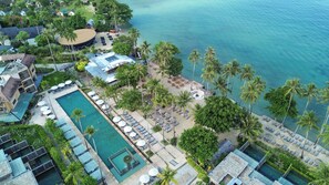 An aerial view of a resort with a swimming pool, beach area, and palm trees. - Dinso Resort & Villas Ko Chang, Vignette Collection by IHG (Ko Chang)