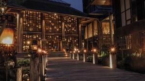 A building with a wooden deck leading to a covered entrance, featuring multiple windows and a central open area. - Dinso Resort & Villas Ko Chang, Vignette Collection by IHG (Ko Chang)