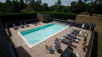 Seasonal outdoor pool, open 9:00 AM to 9:00 PM, pool umbrellas