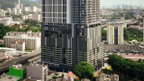 A modern high-rise hotel with multiple floors, a prominent "Icon Regency" sign, and a view of the surrounding cityscape. - Iconic Regency Service Residences - Managed by Iconic Hotel (George Town)