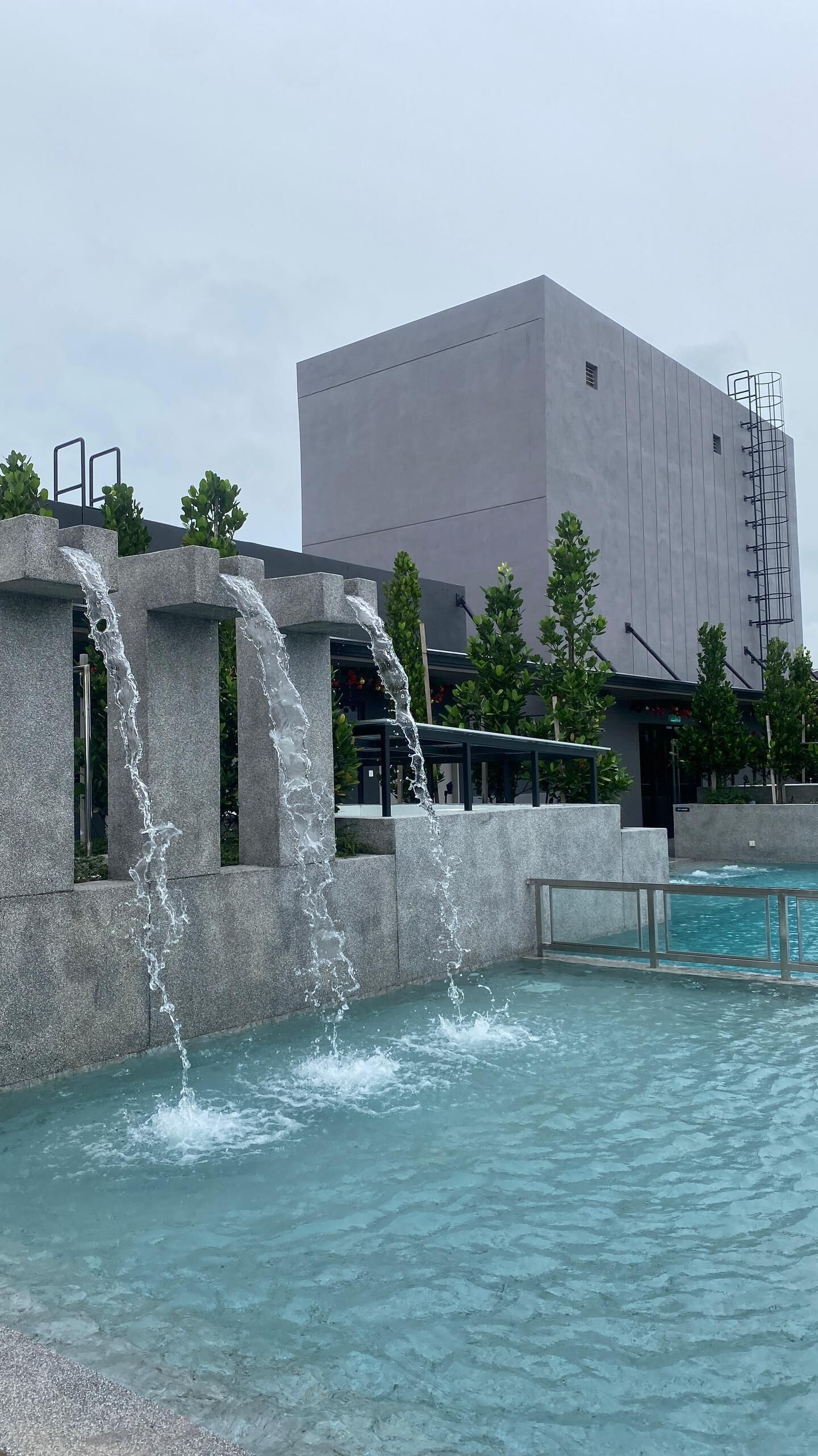 A modern building with a water feature in front.