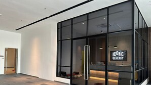 A modern building with large glass windows and a reception area. - Iconic Regency Service Residences - Managed by Iconic Hotel (George Town)