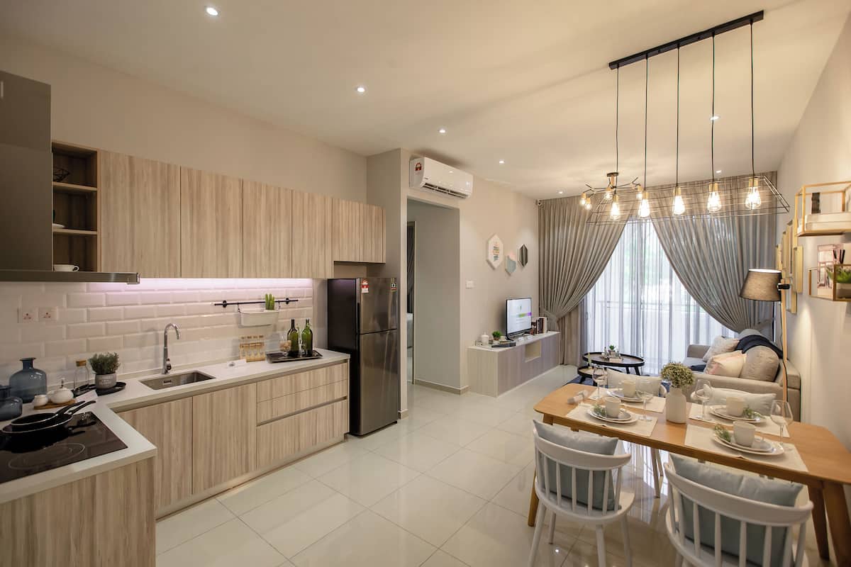 A modern kitchen with a central island, built-in cabinets, and a dining area with a wooden table and chairs.