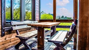 A wooden deck with picnic tables and benches, overlooking a grassy area with trees. - Stunning home in Mielenko with WiFi (Mielenko)