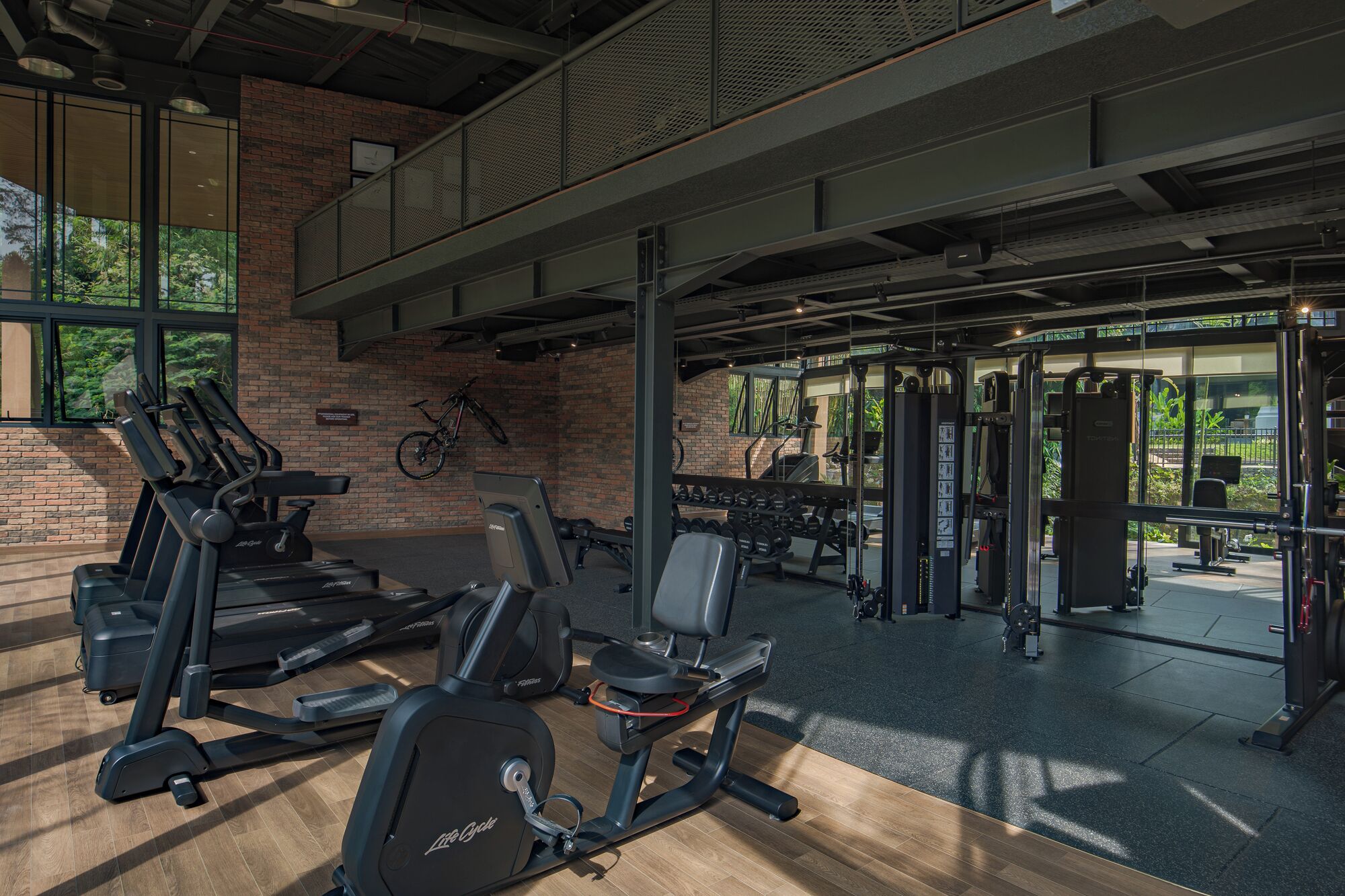 A gym with treadmills, weight machines, and a bike.