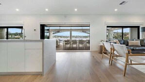 A spacious living area with a view of a bridge and cityscape. - Neighbouring Sydney Harbour Retreats for 12 guests (Drummoyne)