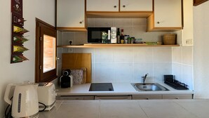 A compact kitchen with white cabinets, a microwave, a toaster, and a sink. - Renovated 2P apartment on slopes, quiet, Pra Loup (Pra-Loup)