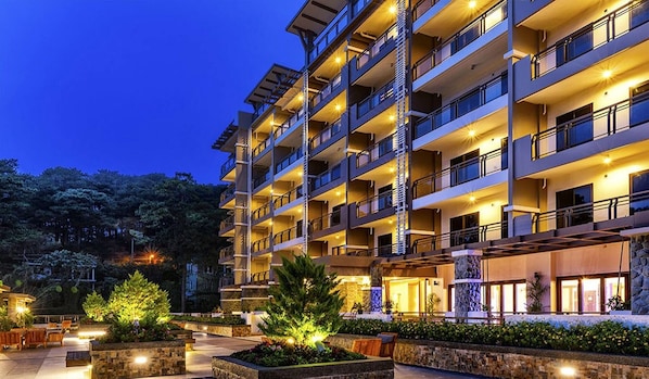 A multi-story hotel with balconies, outdoor seating, and a landscaped garden area. - Serene Premier Cozy Condo With Balcony, 2BR Parking Outlook Drive Baguio (Baguio)