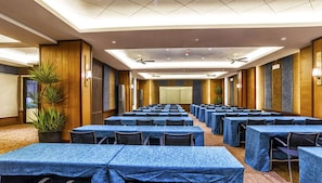 A conference room with rows of tables, ceiling fans, and wall-mounted projectors. - Serene Premier Cozy Condo With Balcony, 2BR Parking Outlook Drive Baguio (Baguio)