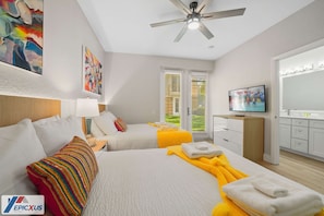 A hotel room with two beds, a ceiling fan, a TV, and a window with blinds. - The Epic 75 Vista Cay Resort Orlando Florida (Orlando)