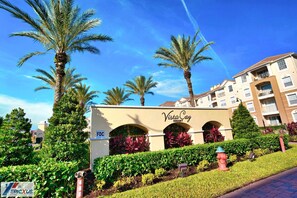 A resort entrance with palm trees, a sign reading "Vista Cay Resort," and a fire hydrant. - The Epic 75 Vista Cay Resort Orlando Florida (Orlando)