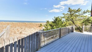 A wooden deck with a view of the beach and ocean. - Oceanfront property with a private pool! (REHOBOTH BEACH)
