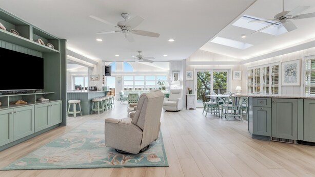 A spacious kitchen with high ceilings, pendant lighting, and a central island. - Oceanfront property with a private pool! (REHOBOTH BEACH)