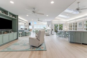 A spacious kitchen with high ceilings, pendant lighting, and a central island. - Oceanfront property with a private pool! (REHOBOTH BEACH)
