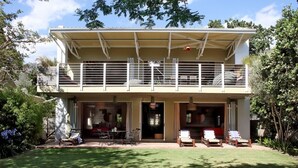 A two-story house with a swimming pool in the foreground. - The Library (Franschhoek)