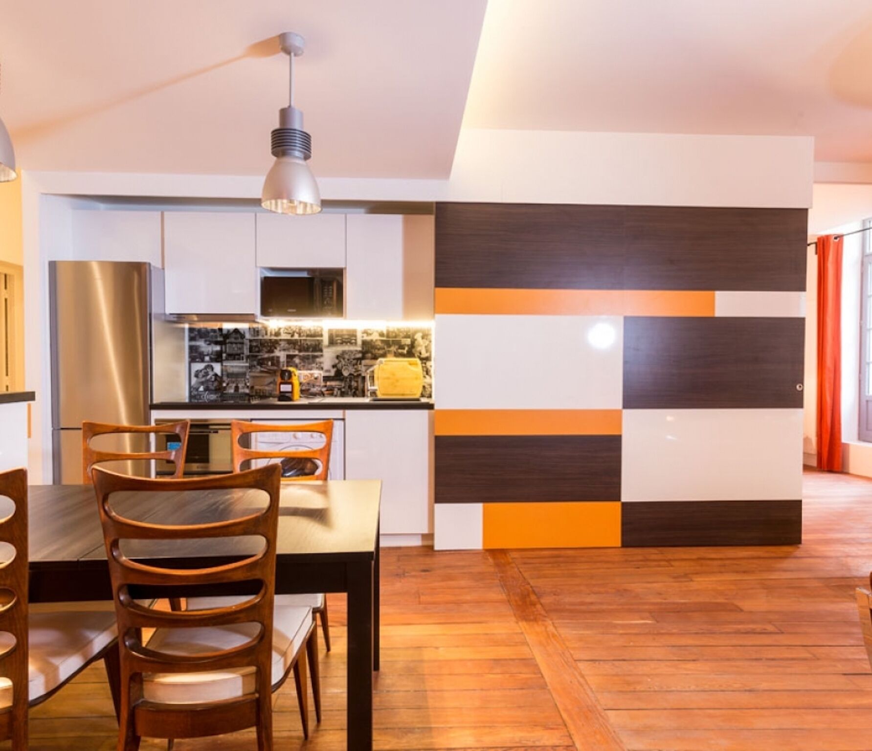 A modern kitchen with a dining area.
