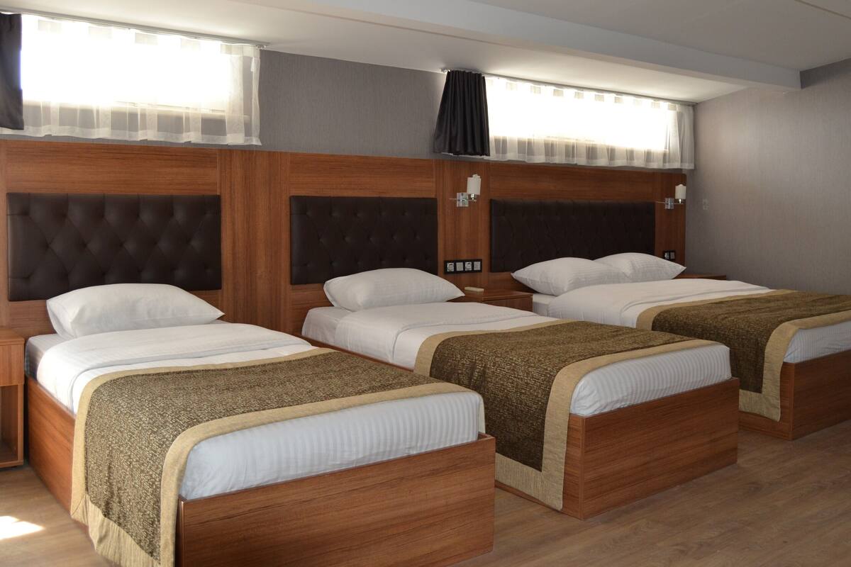 Standard Triple Room, City View | In-room safe, desk, laptop workspace, blackout drapes