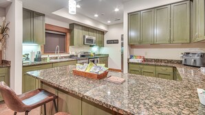 A kitchen with granite countertops, green cabinets, and stainless steel appliances. - Scenic Getaway w/ Fire Pit & Grill in Columbia! (Columbia)
