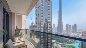 A balcony with a view of a cityscape, including tall buildings and a marina.