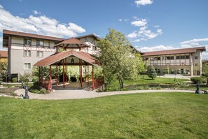 Relax in a serene setting surrounded by well-maintained lawns and a small water feature.