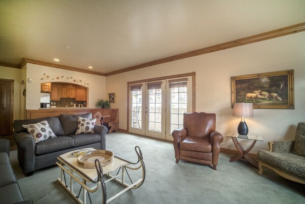 Relax in this inviting living space with a sofa, armchair, and dining area.