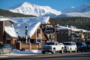 Welcome to Bento's Mountain Bistro, situated in a serene mountain setting with a charming facade and parking area.