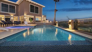 A modern house with a swimming pool, large windows, and outdoor seating. - Salinja Cerca 23-b (Noord)