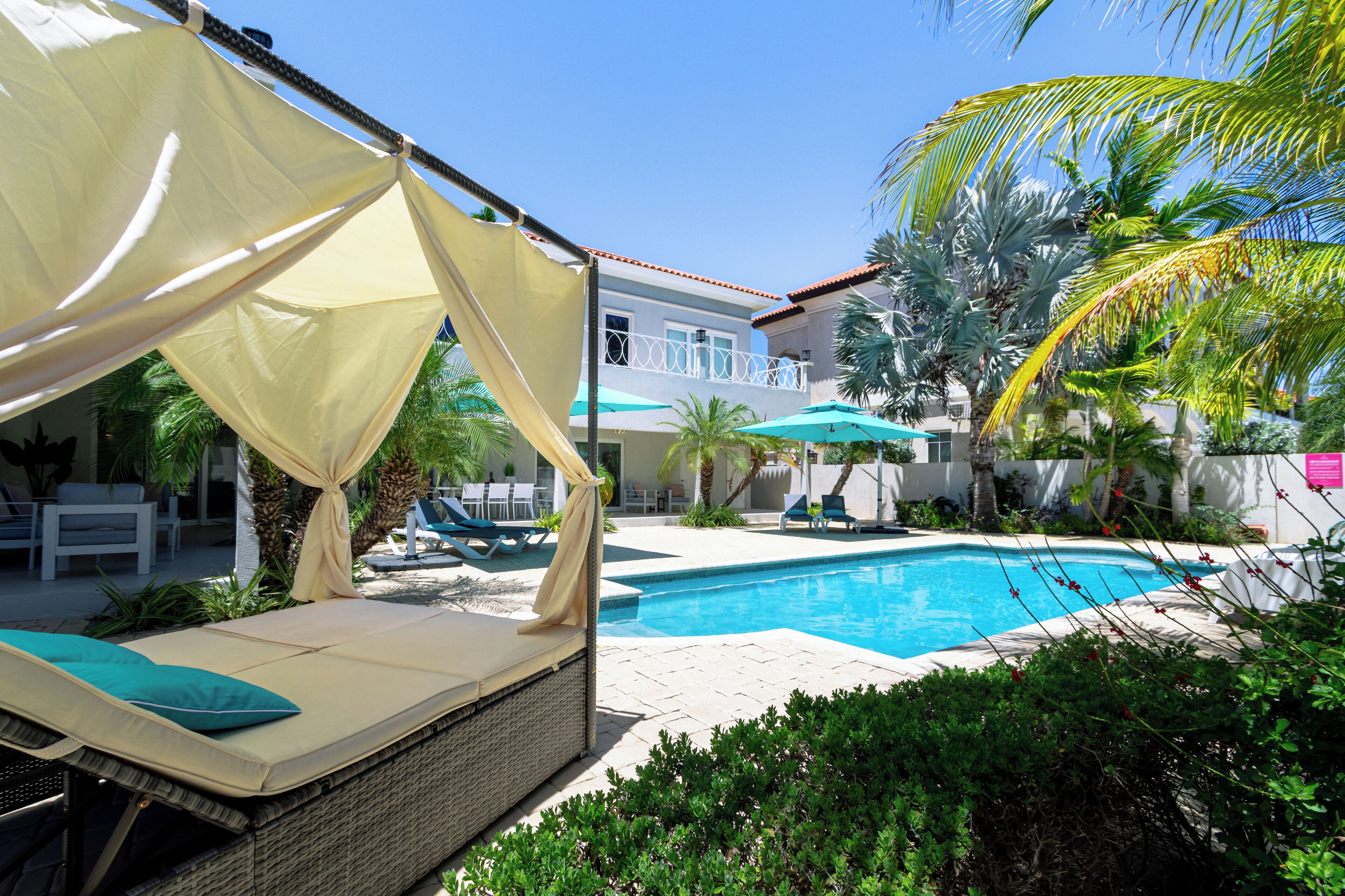 A pool area with lounge chairs and a canopy.