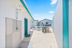 Guests can access the resort's pool area via this corridor, featuring a shower and lounge seating.