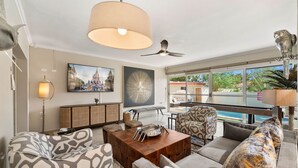 A modern living room with a sofa, coffee table, and a ceiling fan. - Safir 8 (Noord)