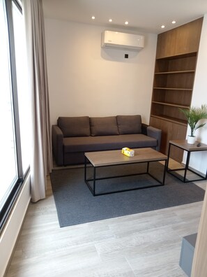 Junior Apartment | Living area | 55-inch Smart TV with satellite channels - ALSHAKREEN SUITES (Amman)