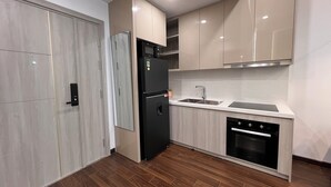 A modern kitchen with a built-in refrigerator, oven, and dishwasher.