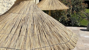 Outdoor umbrellas with a stone building in the background. - Five & You (Josse)