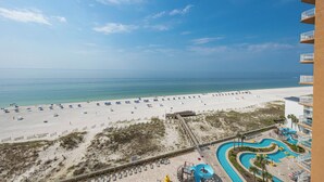 A beach resort with a sandy beach, a pool area, and a view of the ocean. - Phoenix Gulf Towers 806 - Brand NEW Two Bedroom Condo (Orange Beach)