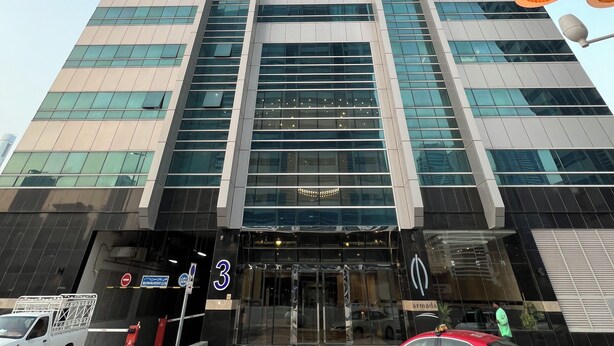 A tall, modern building with a glass facade and a prominent entrance. - Handsome 1BR in Armada Tower 3 (Dubai)