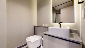 A modern bathroom with a white sink, a mirror, and a toilet. - Mag Eye 920 - Classy Studio Apartment in Meydan (Meydan)
