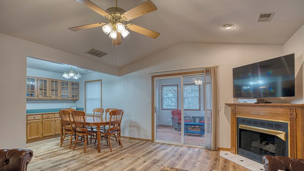 A spacious living room with a fireplace, a dining area with wooden furniture, and a kitchen with wooden cabinets. - Retro '90s 2BR/2BA • Private Entrance • Pet-Friendly • King Bed • 5 M... (Newburgh)
