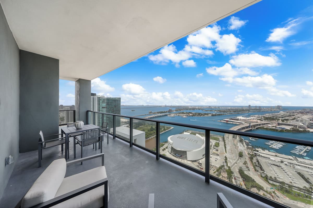 A balcony with a view of a marina and buildings.