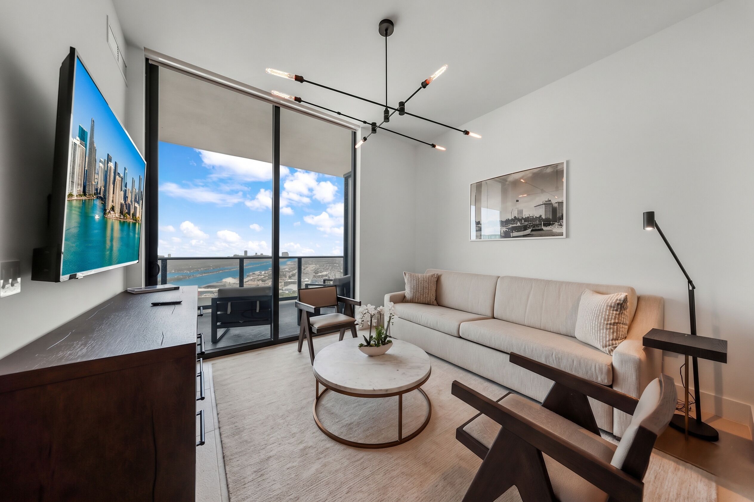 A modern living room with a sofa, coffee table, and TV.