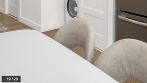 A compact laundry room with two stacked washing machines, a refrigerator, and a white door. - Bakan- Studio Downtown/Old Montreal (Montréal)