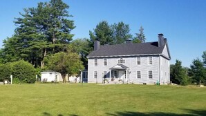 A large, single-story house with a front porch and a well-maintained lawn.