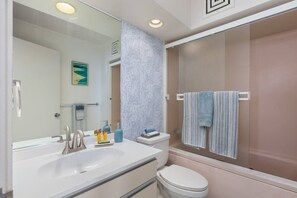 A modern bathroom with a large sink, a toilet, and a shower area. - Ilikai Collection # 12. Corner Oceanfront condo ! (Honolulu)