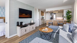 A modern apartment with a living room, kitchen, and dining area.