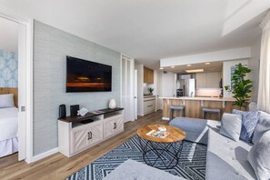 A modern apartment with a living room, kitchen, and dining area.
