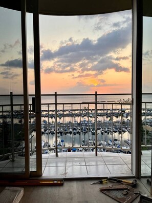 A view from a balcony with a marina and boats below.
