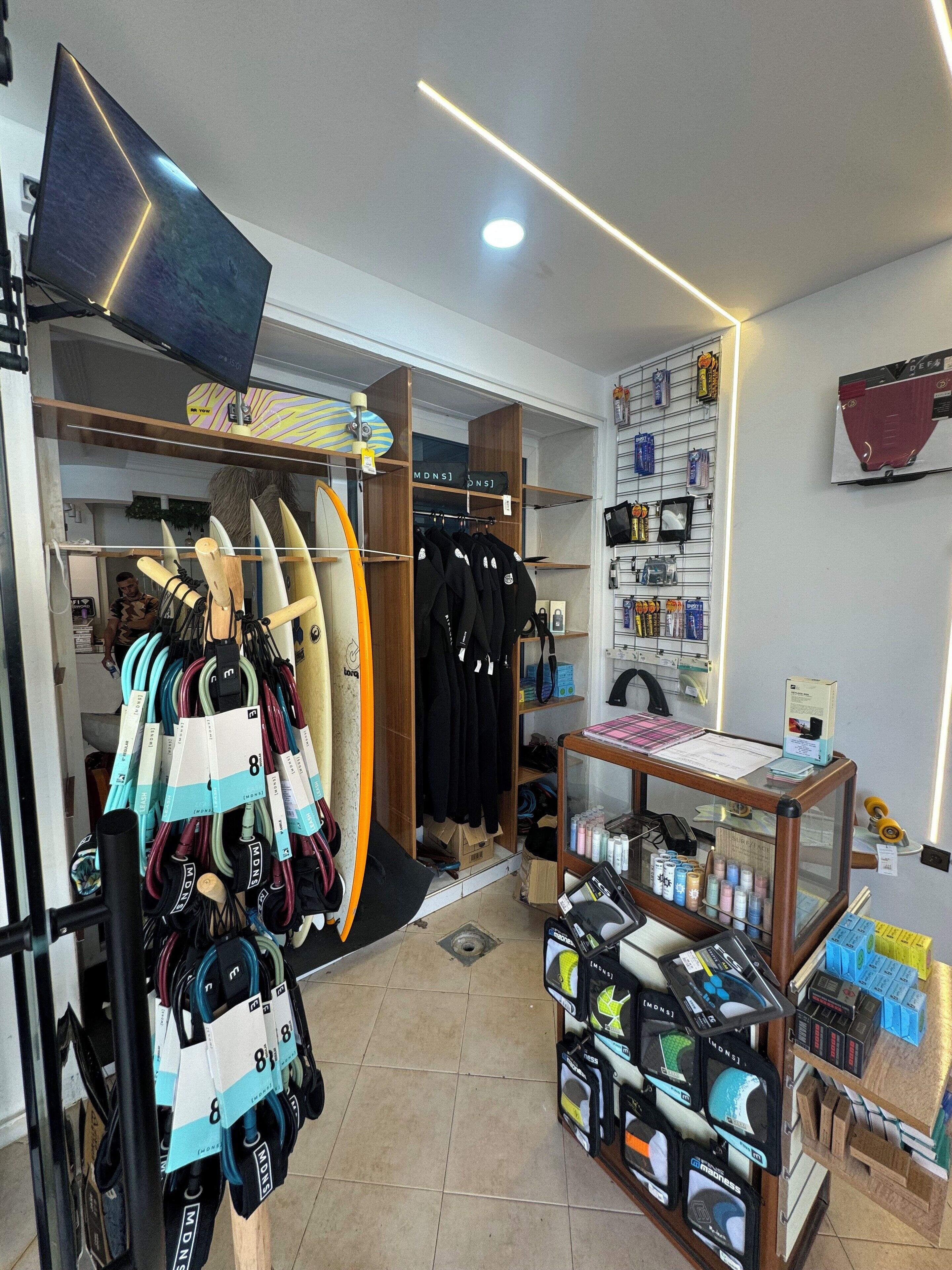 A surf shop with surfboards, wetsuits, and other surfing gear.