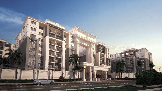 A multi-story hotel with a symmetrical facade, balconies, and a central entrance with columns.