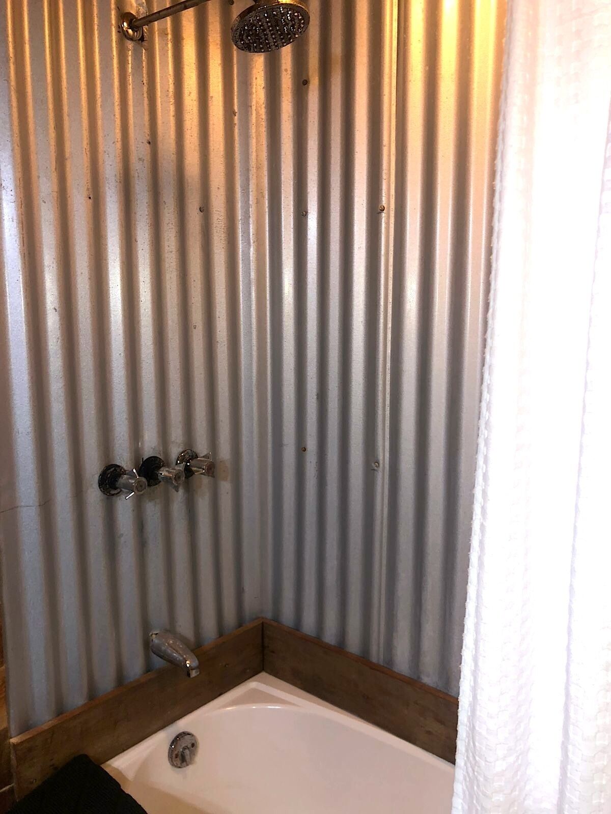 A bathroom with a shower, a bathtub, and a toilet.