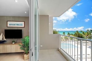 A balcony with a view of a beach and ocean.
