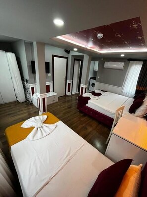 Deluxe Quadruple Room | Egyptian cotton sheets, premium bedding, desk, laptop workspace